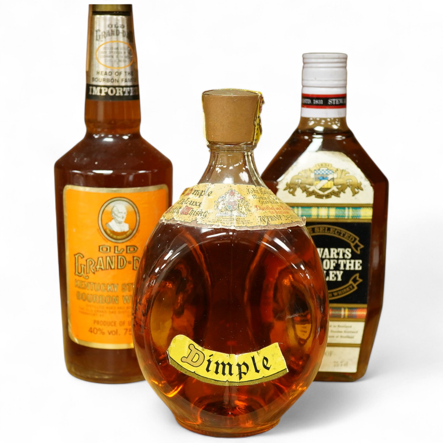 A bottle of Dimple whisky, Old Grand-Dad Bourbon whiskey and Stewarts Cream of the Barley